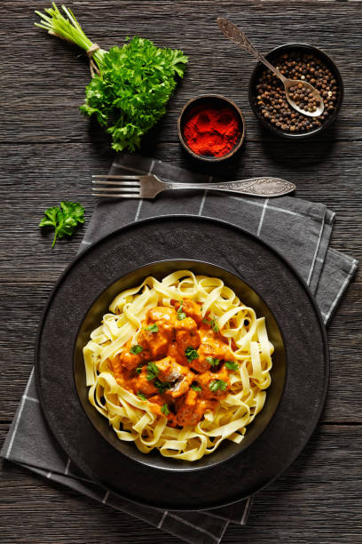 istock Creamy Paprika Pork Chunks over tagliatelle noodle 1613756292