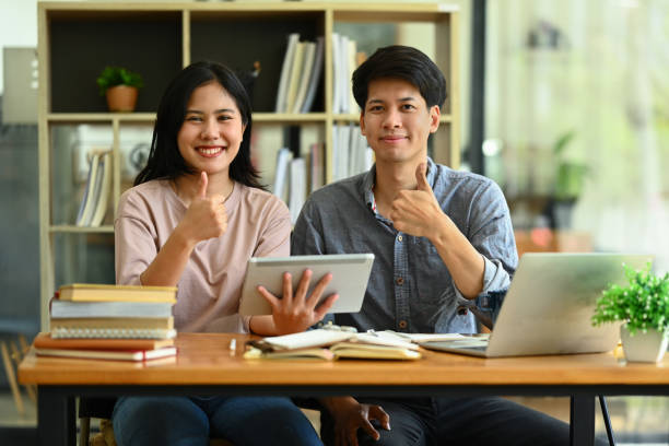 istock Image of university students showing thumbs up and looking at camera. Education, Learning and youth lifestyle. 1613757223