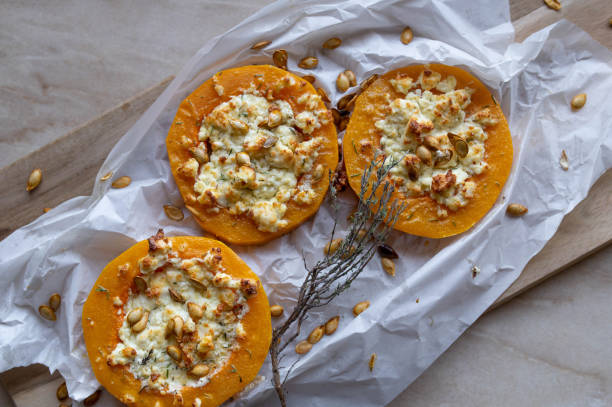 low carb meal with baked butternut squash, feta cheese and roasted pumpkin seeds - butternut squash roasted squash cooked imagens e fotografias de stock