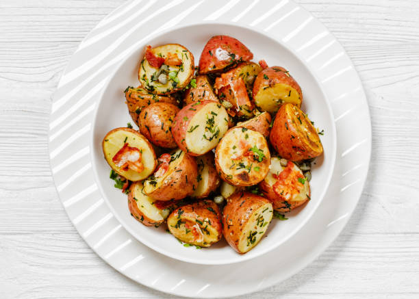 istock Herbs Garlic Potatoes in white bowl, top view 1613757911