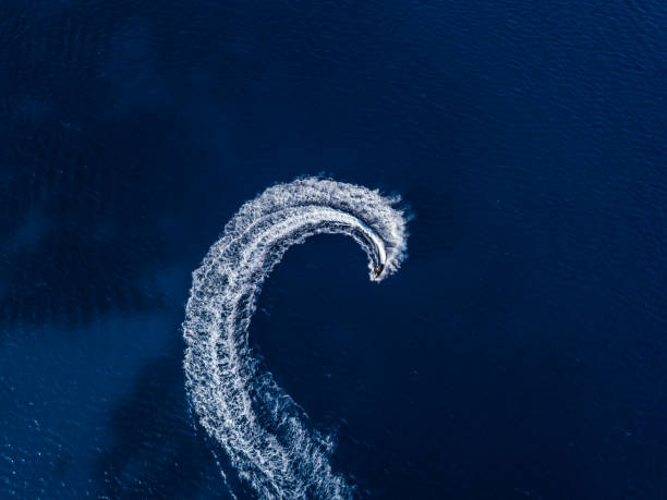 istock Aerial view on jetski in tropical blue waters 1613761102