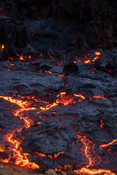 istock Molten lava flow during volcano eruption in Iceland 1613786929