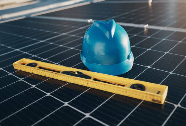 istock Solar panel, level tools and helmet for renewable energy isolated for maintenance and construction. industry, sustainability and engineer equipment on a rooftop for eco friendly project and safety 1613790520