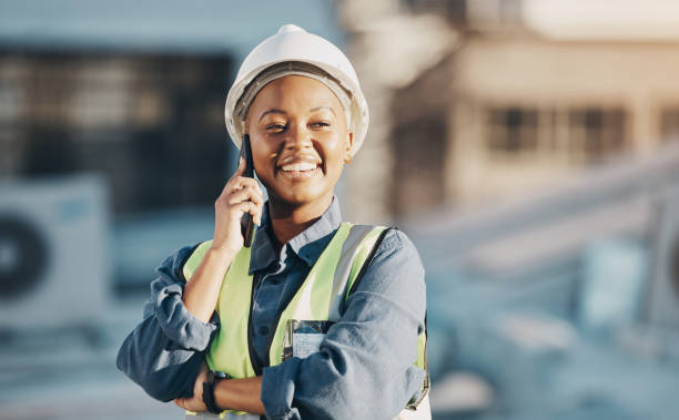 istock Phone call, construction worker and black woman conversation, smile or talk about roof inspection, advice or chat. Cellphone communication, builder or female engineer happy about rooftop architecture 1613790696