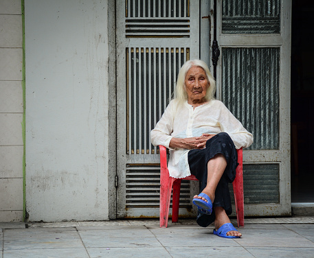 Hanoi, Vietnam - May 23, 2016. Portrait of old woman at ancient town in Hanoi, Vietnam.