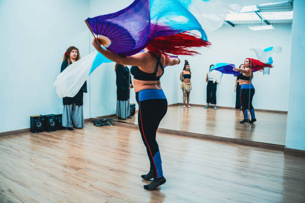 istock Belly dancer rehearsing choreography at dance studio 1613819179