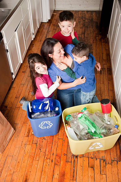 istock Hispanic mother and three kids recycle 161383527
