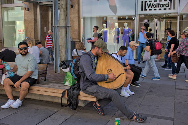 un músico desconocido toca un instrumento musical punteado. - vienna street musician music musician fotografías e imágenes de stock