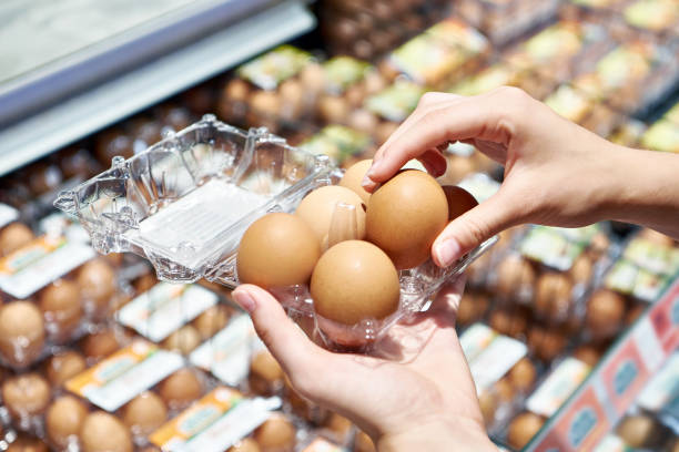 istock Woman with packing eggs in shop 1613886804