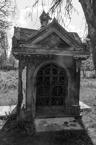 Old stone crypt on the ancient cemetery. Black and white tone