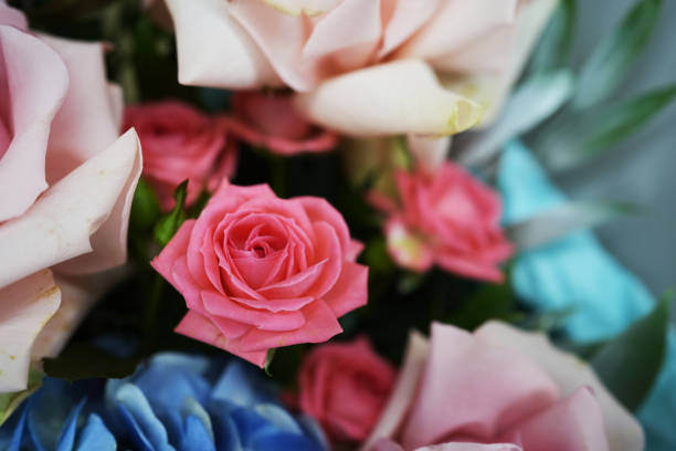 Beautiful colorful mixed flower bouquet. Man hands holding flowers bouquet, dark background, copy space, close-up