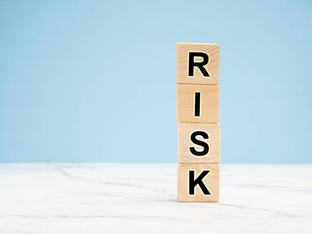 istock Wooden cubes with the letters RISK on a light blue background 1613932533