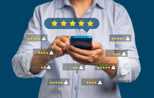 istock Satisfaction and feedback surveys. A man in a blue shirt using a smartphone gives the five-star icon a rating of very impressed for service while standing over a red background 1613935167