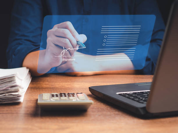 istock A businessman uses a pen to sign electronic documents on digital documents on a virtual screen. Electronic signature and paperless office concept 1613935204