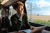 A man using a laptop during a train ride