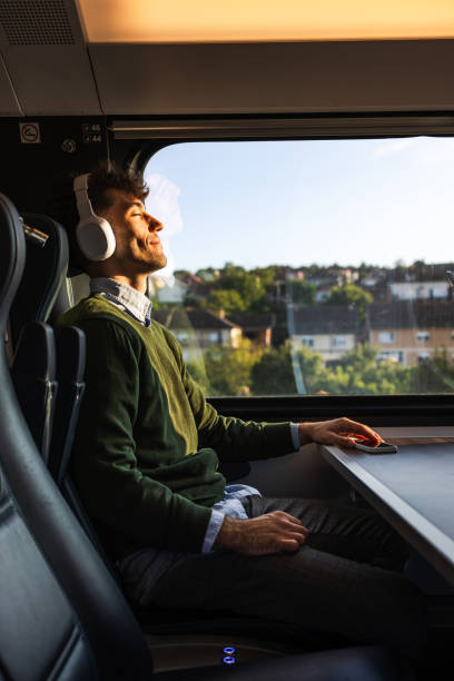 istock Side view of a man sleeping during a train ride 1613945266