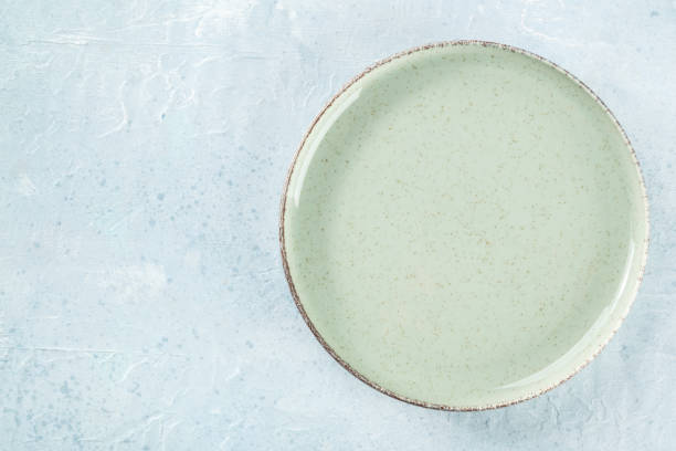 istock An empty green plate, shot from above on a slate background 1613996225