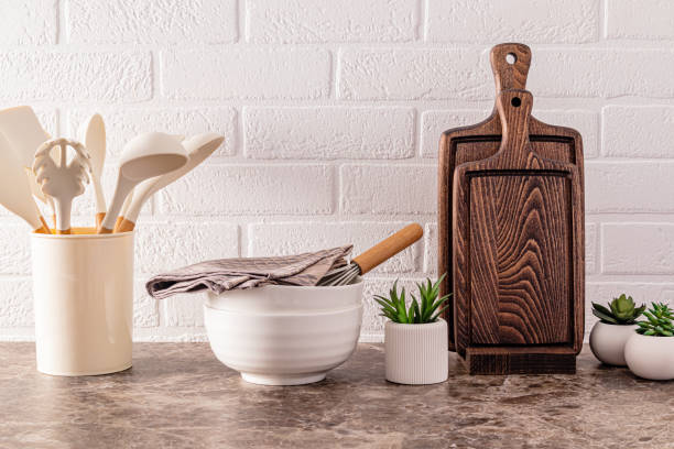 istock Kitchen utensils made of environmentally friendly materials on a modern marble countertop with indoor flowers. White brick wall. 1614001672
