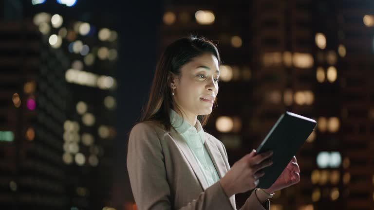 Business woman, tablet and thinking in city or on balcony with digital pen for accounting and financial trading at night. Corporate person with stock market ideas, writing and technology in bokeh