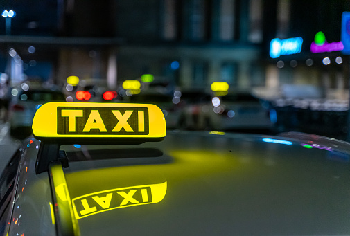 Close up of Taxis sign on car at night, Germany Leipzig
