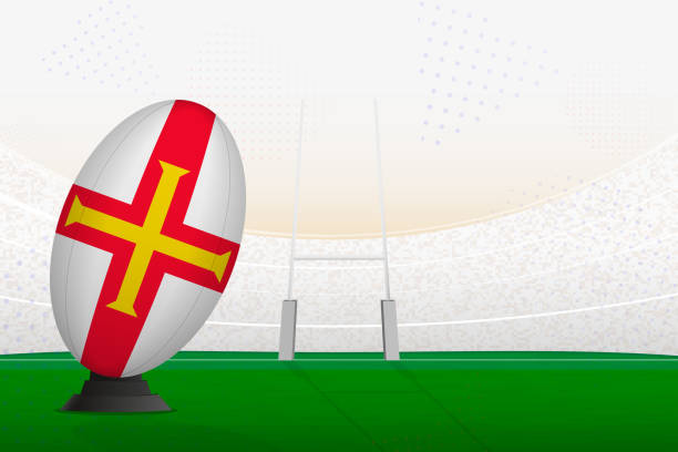 istock Guernsey national team rugby ball on rugby stadium and goal posts, preparing for a penalty or free kick. 1614013321