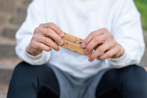 Shot focused on two hands holding a protein bar.
