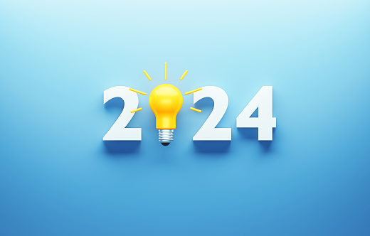 White 2024 and yellow lightbulb on blue background. Horizontal composition with copy space.