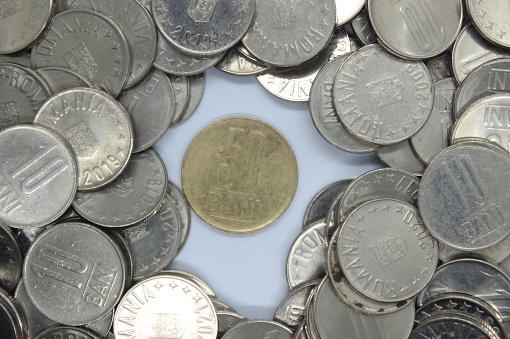 Close-up of Romanian currency coins of 50 bani and 10 bani stack