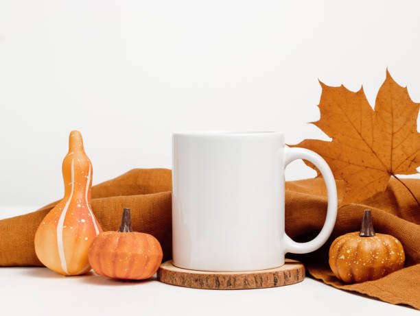 istock Mockup mug with autumn maple leaf and pumpkin decoration 1614050494