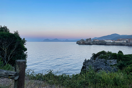 Horizontal sea line in the evening sunlight over sky background. Blue hour sunset. Summer adventure or vacation concept. Copy space.