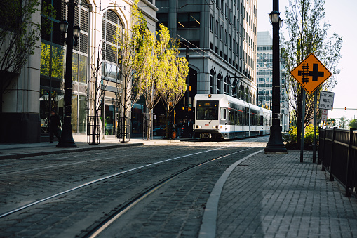 Crosswalk and a blurred tram in Jersey City.