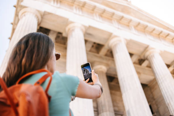 Tourist taking photo of National Library of Greece in Athens stock photo