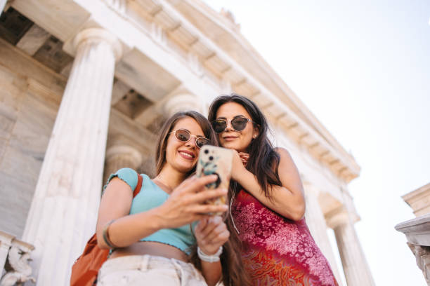 Friends in front of a National Library of Greece in Athens stock photo