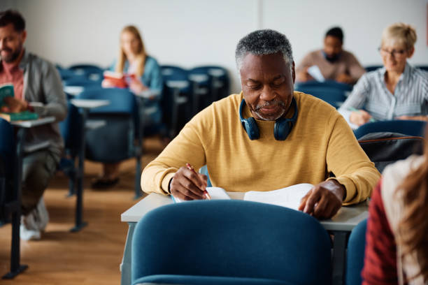 istock Older black man learning during adult education course in the classroom. 1614141923