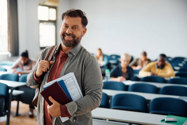 istock Happy mature student in lecture hall looking at camera. 1614142460