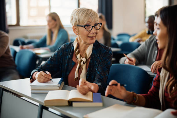 istock Female adult learners communicating during a class in lecture hall. 1614143523