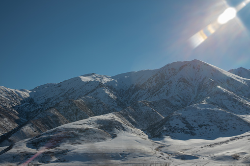 mountain chain in snow under a sparkle sun
