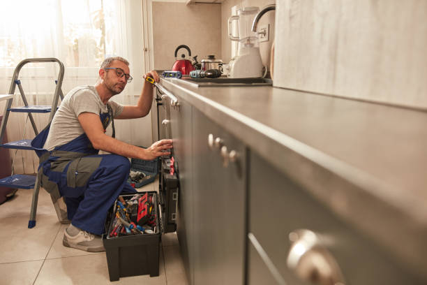 istock Handyman fixing kitchen cabinets in the apartment. 1614172907