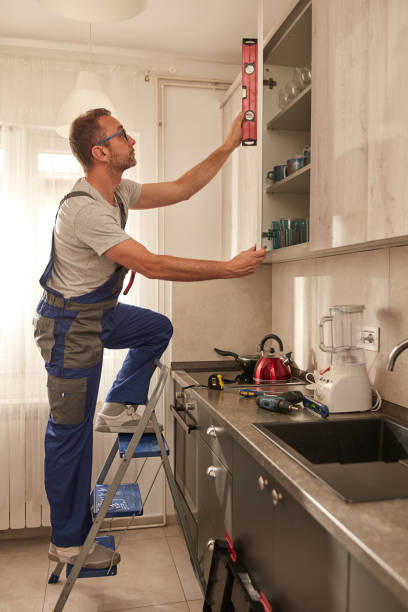 istock Handyman fixing kitchen cabinets in the apartment. 1614172947