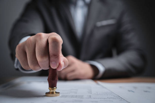 istock Closed up businessman hand using wooden stamping to document approve and reject document or project concept, copy space. 1614178507