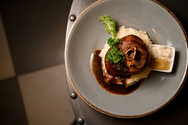istock top view of fried pork knuckle garnished with herbs on a plate on the table 1614178509