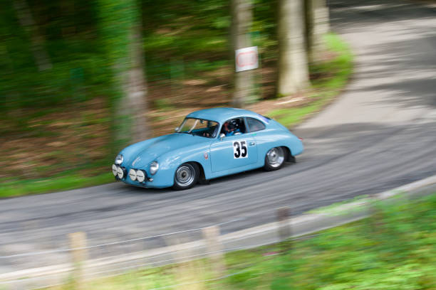Fast and famous german old timer car. 08 13 2023
Theux Belgium.
Old mythical Porsche of 1956 driving at full speed on a country road in a Belgian race called (the climb of the maquisard) with a motion blur. 1950s racing car stock pictures, royalty-free photos & images