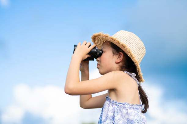 istock child looking into the distance with binoculars 1614184593