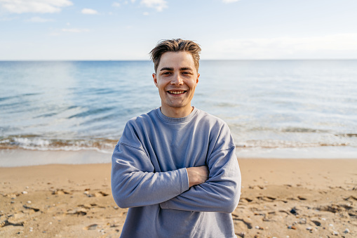 Portrait of a handsome young man on the beach in Nea Flogita, Greece.