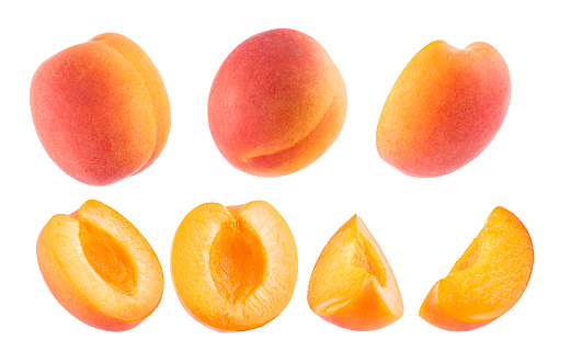 Ripe orange apricot with pink side - collection, whole and cut on half, pieces, different sides, closeup, details, isolated on white background. Summer fresh natural fruits as design elements.
