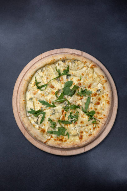 istock Italian cuisine. Delicious pizza on a dark background 1614191429