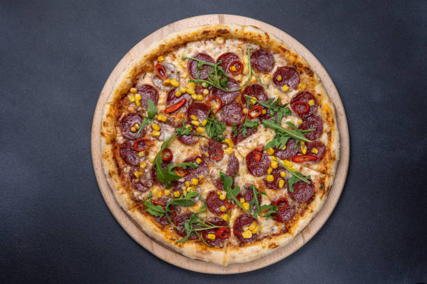 istock Italian cuisine. Delicious pizza on a dark background 1614192497