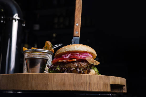 istock Delicious hamburger with cutlet, greens, sauce and tomatoes 1614203248