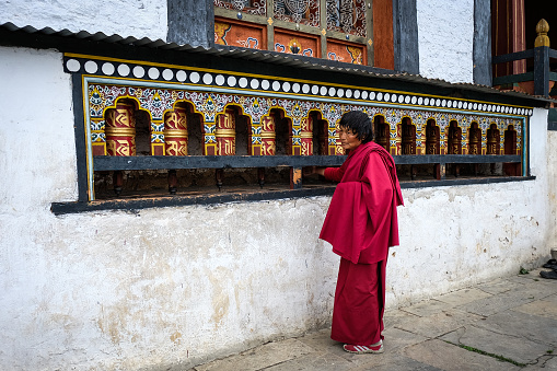 Thimphu, Bhutan - Aug 31, 2015. A monk praying at monastery in Thimphu, Bhutan. It is believed that Buddhism was introduced to Bhutan in the late 8th century.