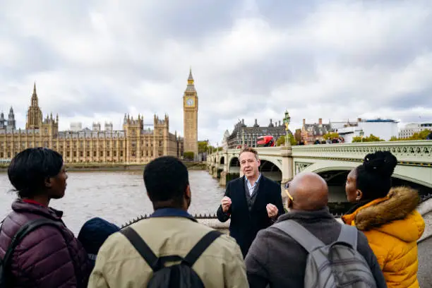 Photo of London tour guide holding forth on the fascinating history of the Houses of Parliament